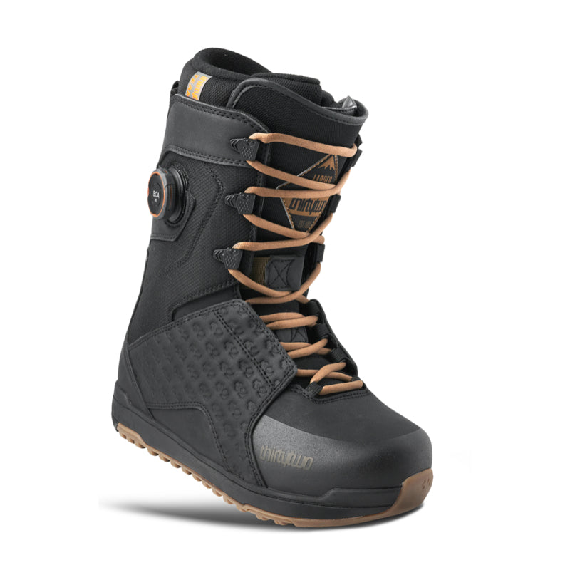Black snowboard boot with brown laces on a white background