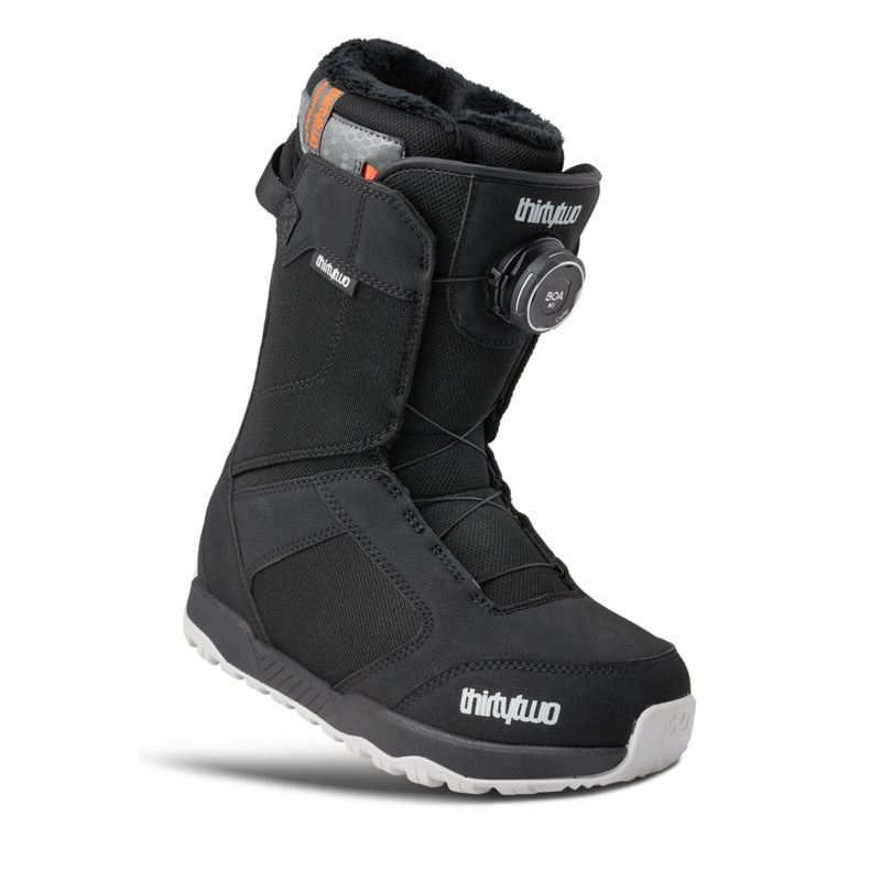 Black snowboard boot with 'thirtytwo' branding on a white background