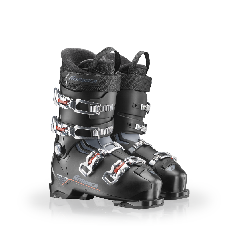 Black ski boots with silver buckles on a white background