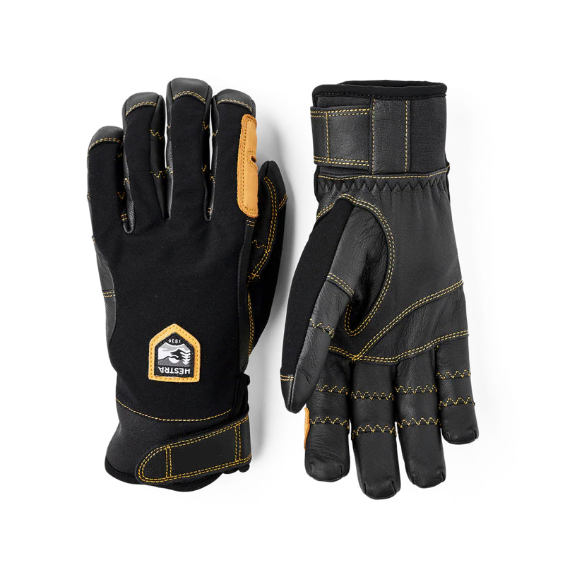 A pair of black heavy-duty work gloves shown from both the back and palm sides, featuring tan protective panels and yellow contrast stitching. A shield-shaped patch on the back glove displays the brand name 'Black Dragon'.
