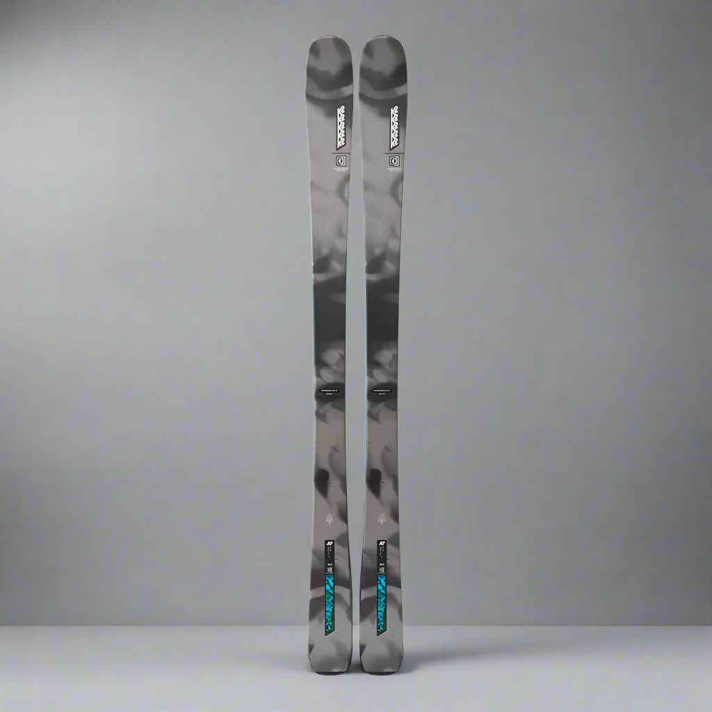 Pair of skis with a camouflage pattern on a white background