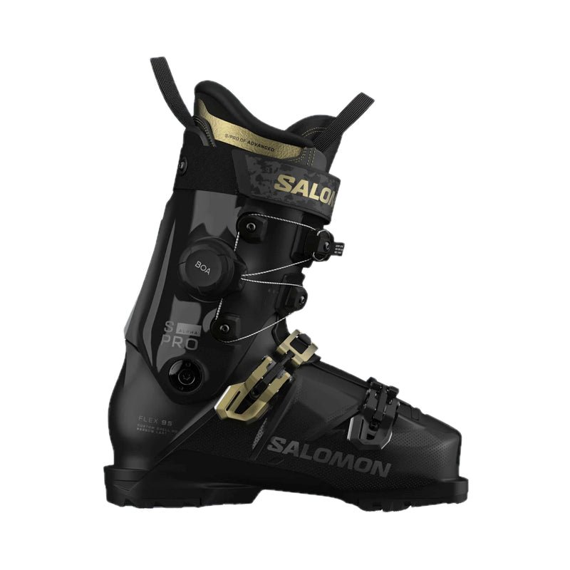 A Salomon ski boot in black with gold accents, featuring a dial closure system and a quick-release buckle, shown from a side profile on a white background.