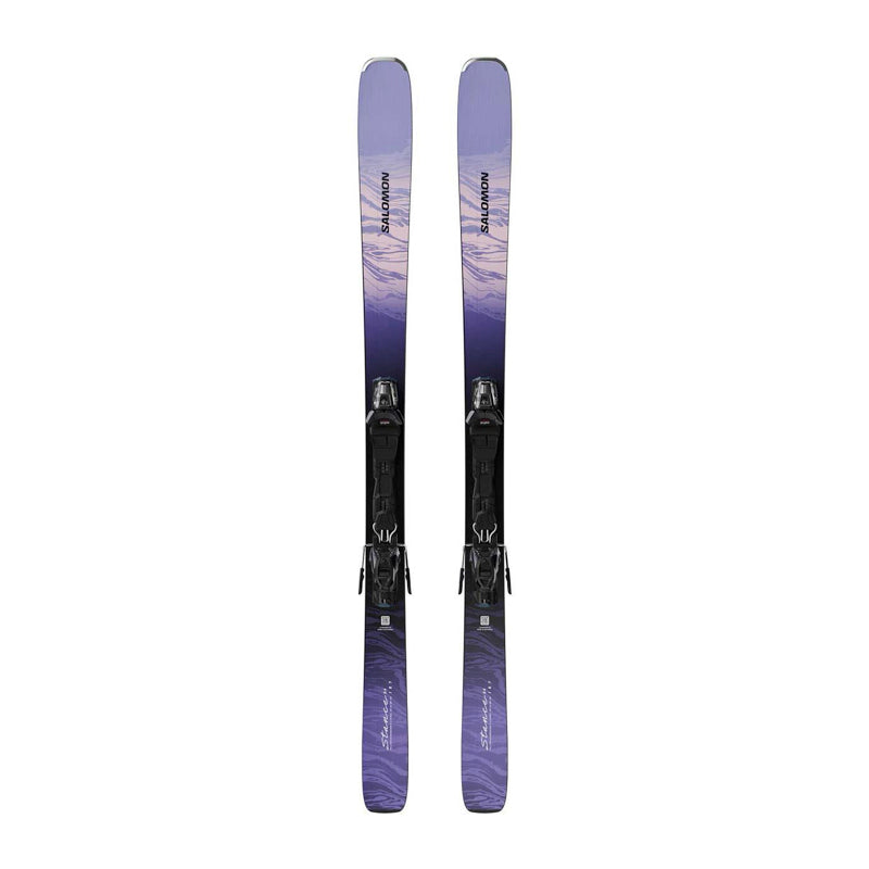A pair of Salomon alpine skis with black bindings, featuring a purple and lavender mountain-patterned graphic on a clean white background.