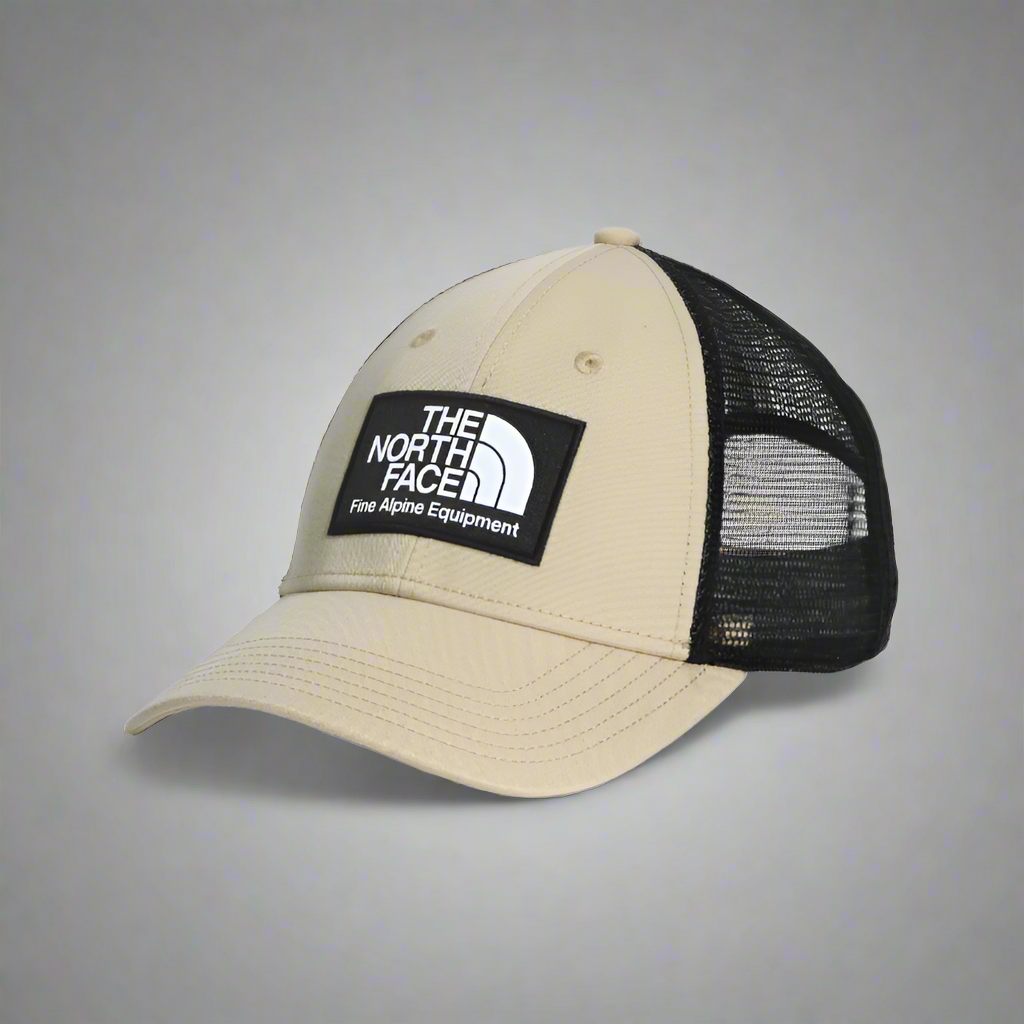 Beige and black cap with The North Face logo on a white background