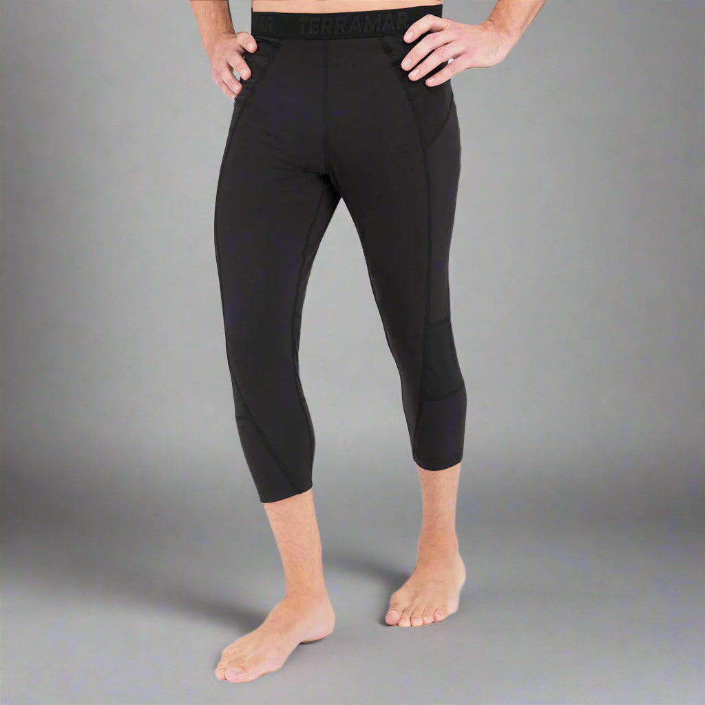 Person wearing black athletic pants on a gray background