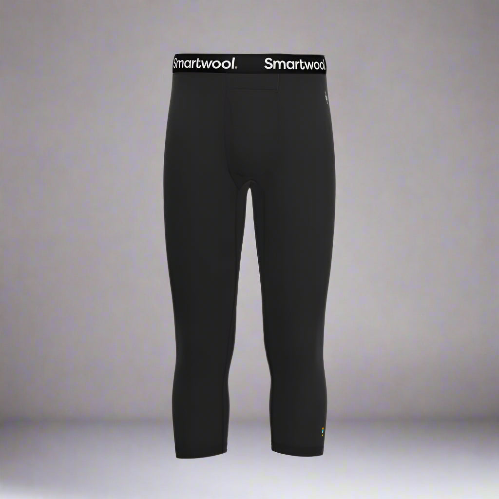 Black leggings with Smartwool logo on a grey background