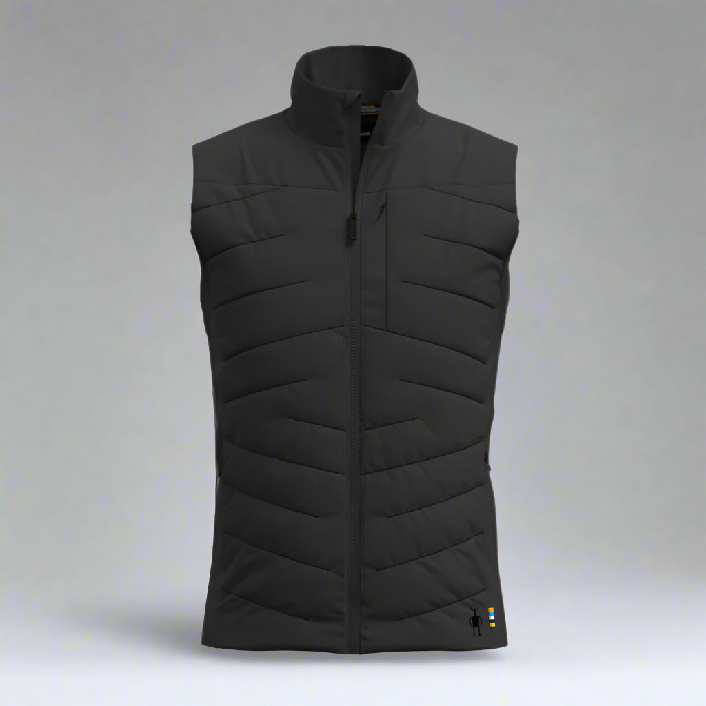 Black quilted vest on a grey background
