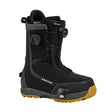 Black snowboard boot with yellow sole on a white background