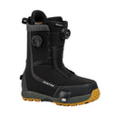 Black snowboard boot with yellow sole on a white background