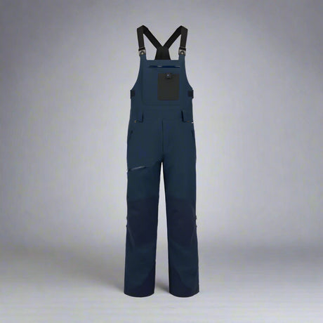Navy blue bib overalls on a white background
