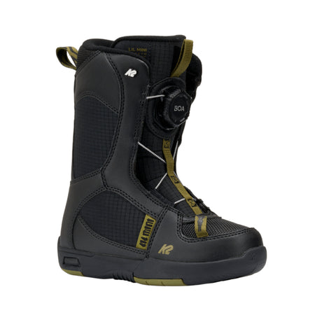 Black snowboard boot with green accents on a white background