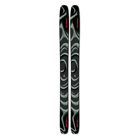 A pair of Salomon ski tips with a black base featuring mint green abstract wave patterns and pink brand lettering, shown vertically on a plain white background.