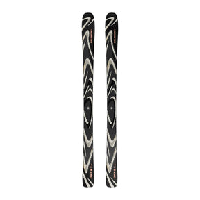 A pair of skis with a black base featuring a swirling zebra-like pattern in beige and white, with small red and orange logo details near the tips.