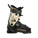 Salomon Speed Pro ski boot in black and beige with gold accents, featuring dual BOA dials and a quick-release buckle system, shown against a plain white background.