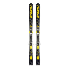 A pair of black Stockli ax ski boots with bright yellow branding and accents, shown vertically against a plain white background.