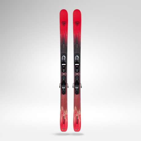 Red and black skis with bindings on a gray background