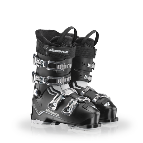Black ski boots with silver buckles on a white background