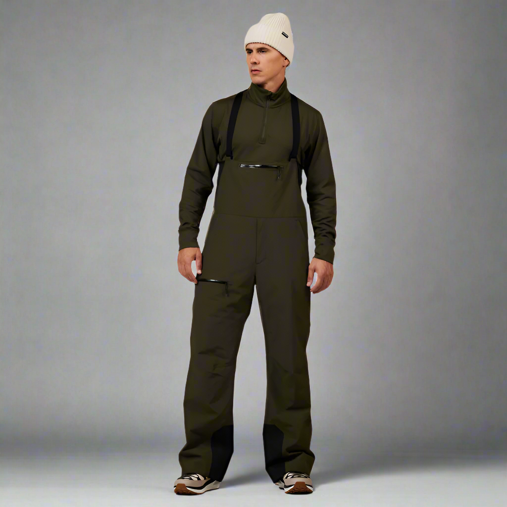 Person wearing a green bib overalls and white beanie on a white background