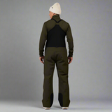 Person wearing a green jacket and pants with a white beanie on a white background