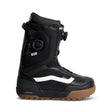 Black snowboard boot with brown sole on a white background