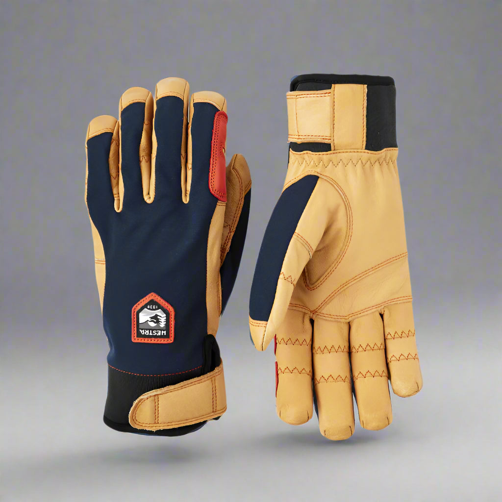 Pair of gloves with blue and tan design on a grey background