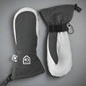 Pair of grey and white mittens with a visible Hestra logo on a grey background