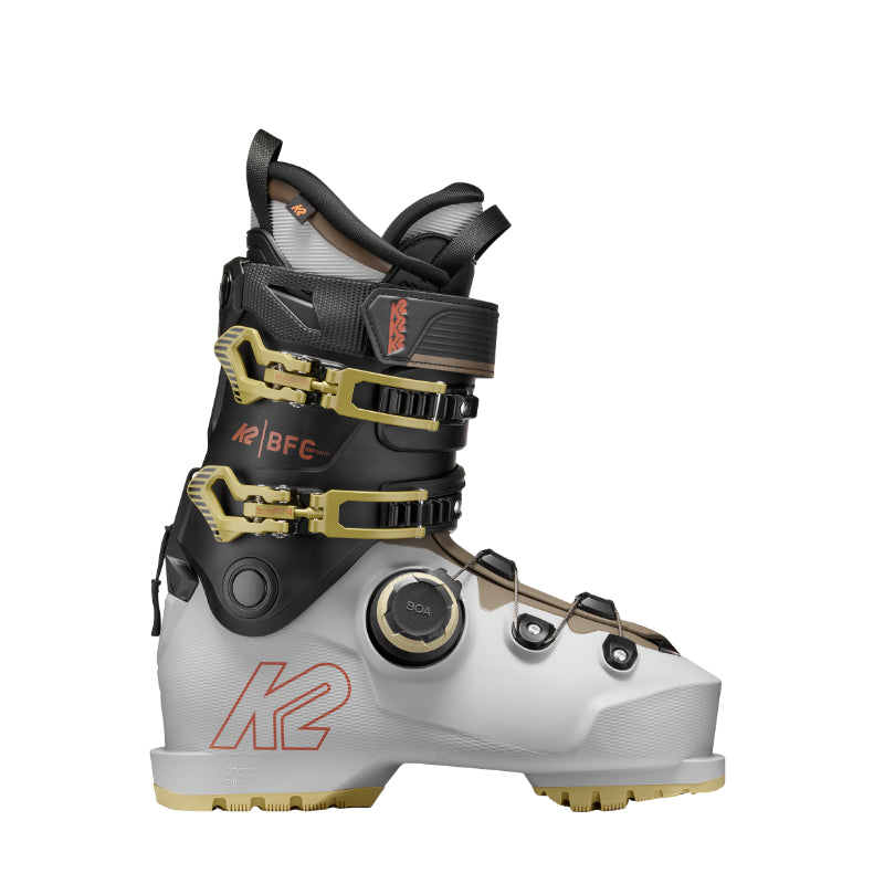 White and black ski boot with gold accents on a white background