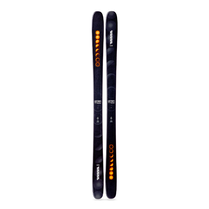 Two black skis with orange and white designs on a white background
