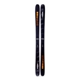 Two black skis with orange and white designs on a white background