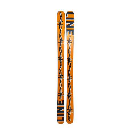 Two orange skis with barbed wire design and 'Line' branding on a white background