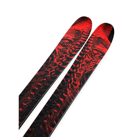 Red and black patterned skis on a white background