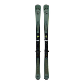 Pair of green skis with bindings on a light gray background